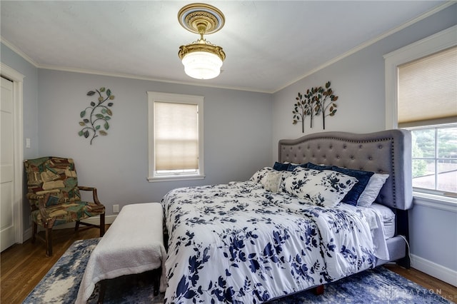 bedroom with dark hardwood / wood-style flooring and ornamental molding