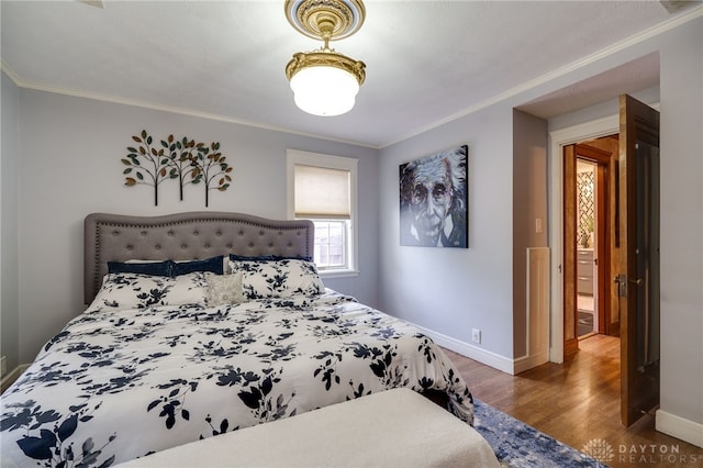 bedroom with ornamental molding and dark hardwood / wood-style floors