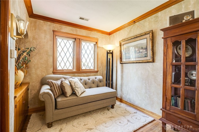 sitting room featuring hardwood / wood-style floors and crown molding