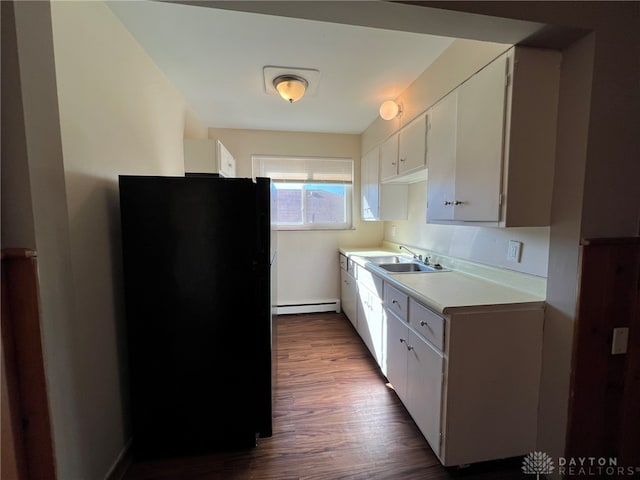 kitchen with black refrigerator, white cabinetry, wood-type flooring, and a baseboard radiator