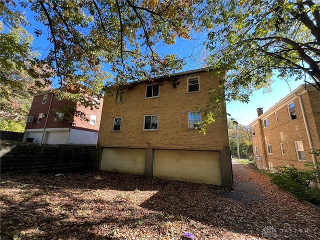 rear view of property featuring a garage