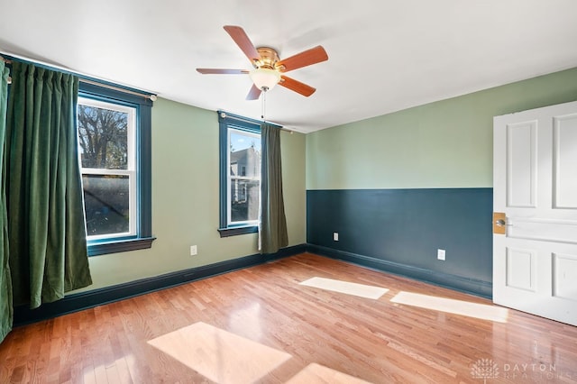 spare room featuring light wood-type flooring and ceiling fan