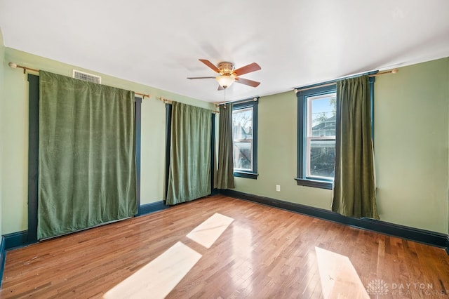 spare room featuring ceiling fan and light wood-type flooring