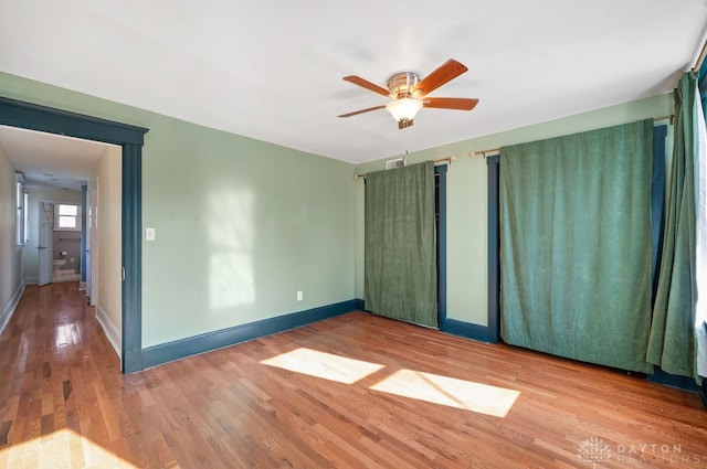 unfurnished room with wood-type flooring and ceiling fan