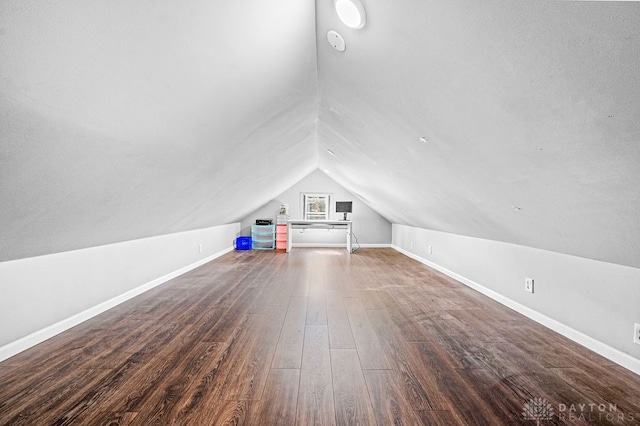 additional living space featuring dark hardwood / wood-style flooring and vaulted ceiling