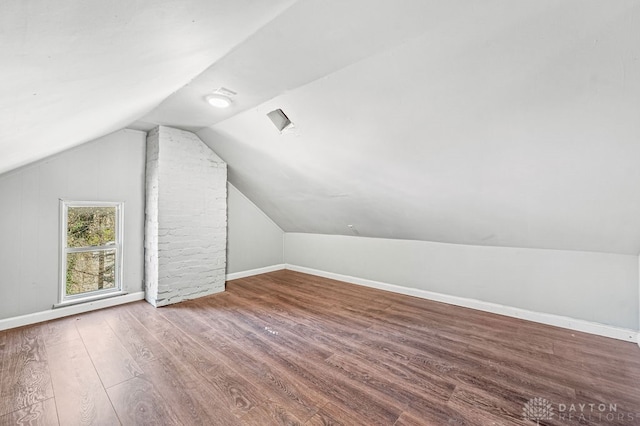 bonus room with hardwood / wood-style floors and lofted ceiling