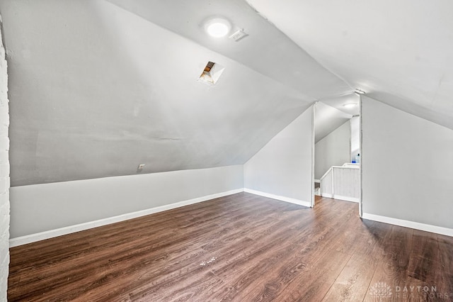 bonus room featuring dark hardwood / wood-style flooring and vaulted ceiling