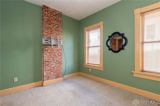 carpeted spare room featuring a textured ceiling