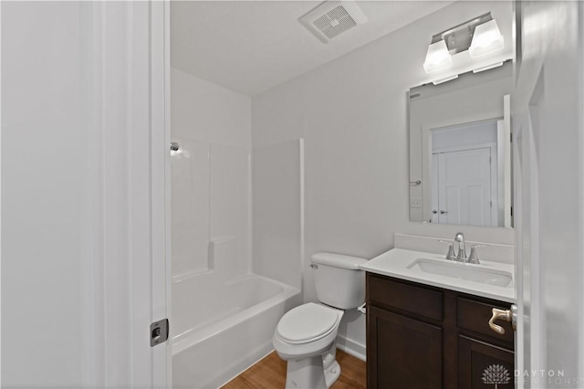 full bathroom featuring vanity, wood finished floors, visible vents, baseboards, and toilet