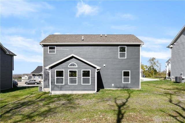 back of house featuring a lawn and cooling unit