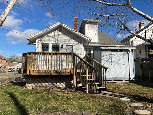 back of house with a wooden deck and a yard