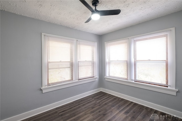 empty room with dark wood-type flooring, a textured ceiling, and ceiling fan