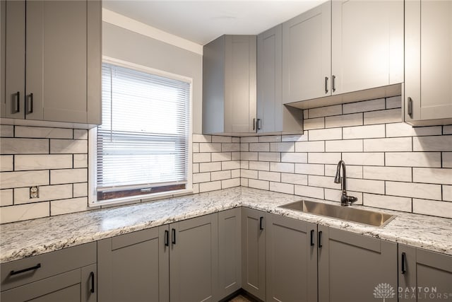 kitchen with gray cabinets, sink, and decorative backsplash