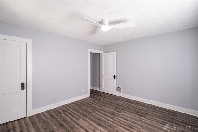 unfurnished room featuring a textured ceiling, dark wood-type flooring, and ceiling fan