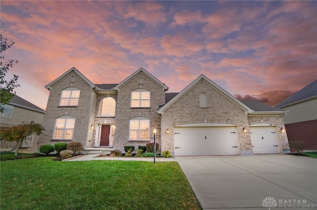 french provincial home featuring a lawn and a garage