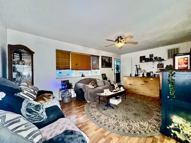 living room with hardwood / wood-style floors and ceiling fan