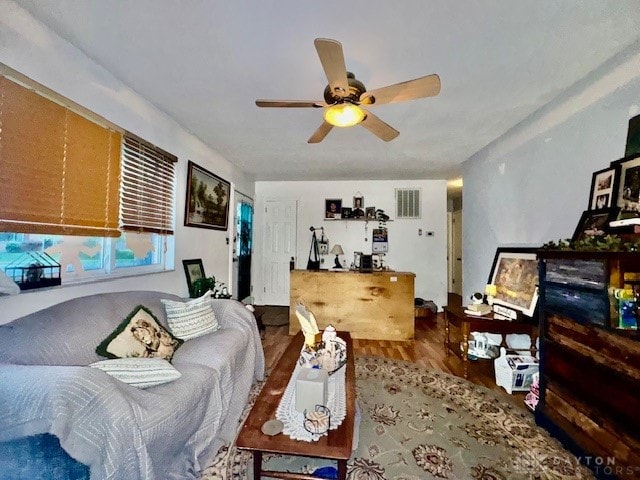 living room with hardwood / wood-style floors and ceiling fan