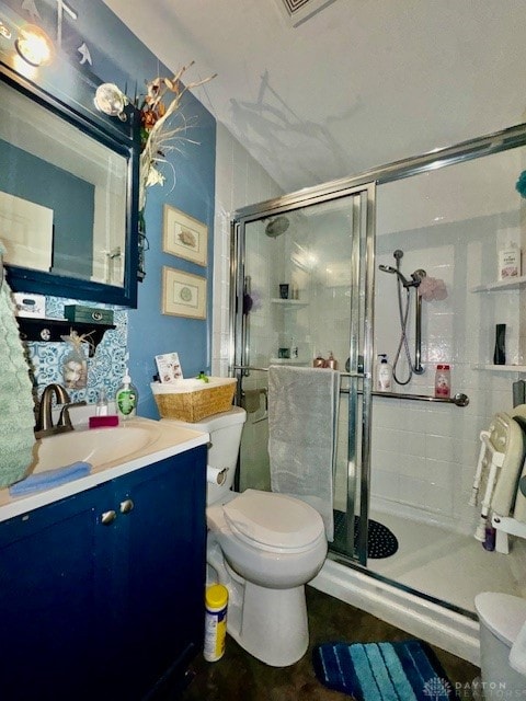 bathroom with walk in shower, vanity, toilet, and vaulted ceiling