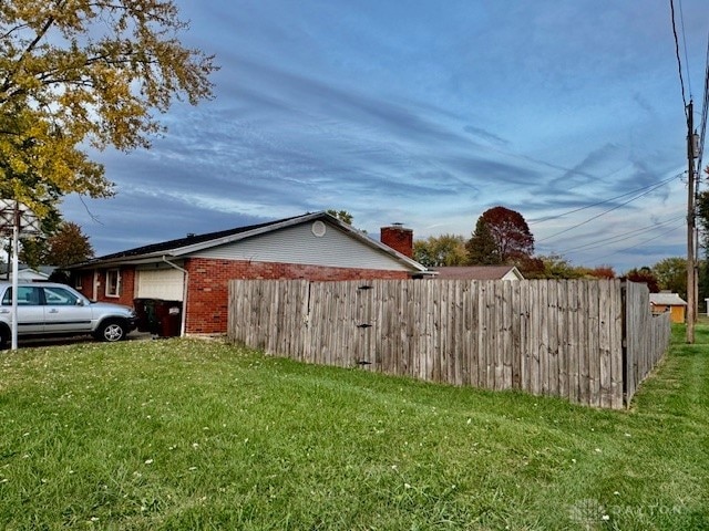 view of home's exterior with a lawn