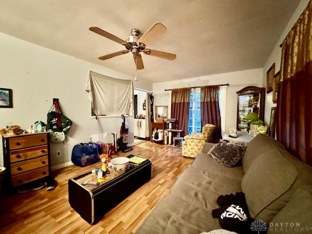 living room with ceiling fan and light wood-type flooring