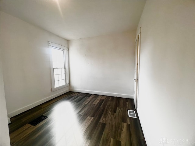 empty room featuring dark hardwood / wood-style flooring