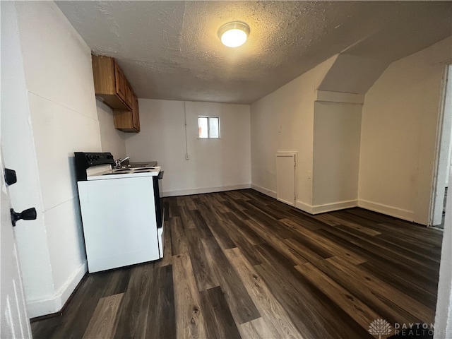 laundry area featuring dark hardwood / wood-style floors, a textured ceiling, and washer / clothes dryer