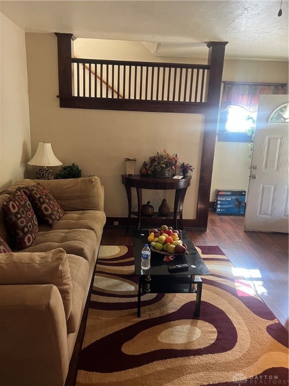 living room with hardwood / wood-style floors and a textured ceiling