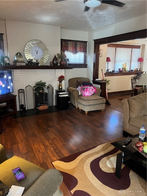 living room featuring hardwood / wood-style floors, ceiling fan, plenty of natural light, and a textured ceiling