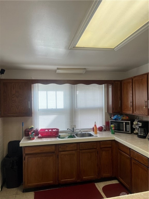 kitchen featuring sink and light tile patterned floors