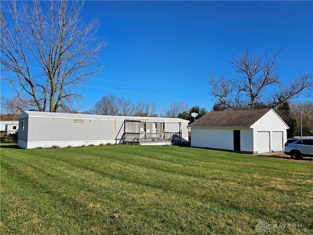 exterior space with an outbuilding and a detached garage