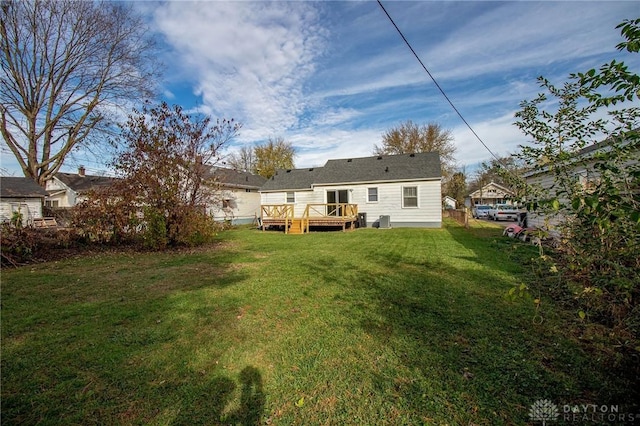 rear view of house with a yard and a deck