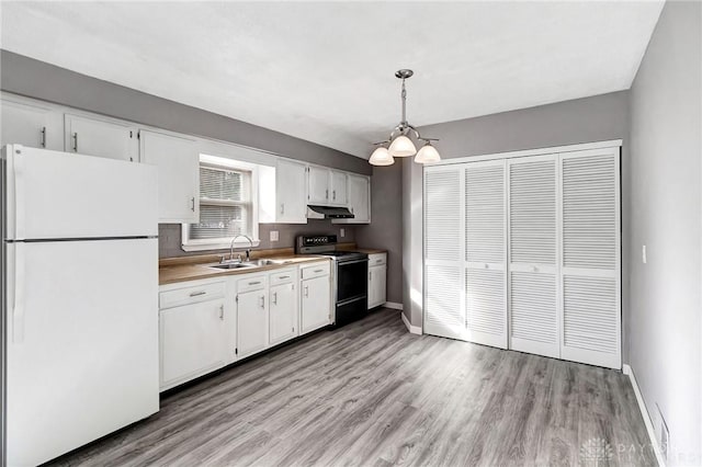 kitchen featuring sink, hanging light fixtures, black / electric stove, white fridge, and white cabinetry