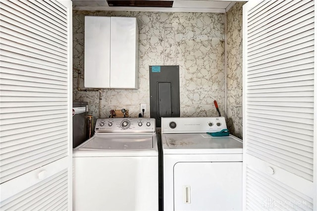 laundry area with washing machine and clothes dryer and electric panel