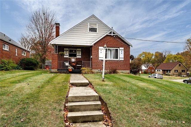 bungalow featuring a porch and a front lawn