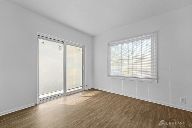 spare room featuring dark wood-type flooring