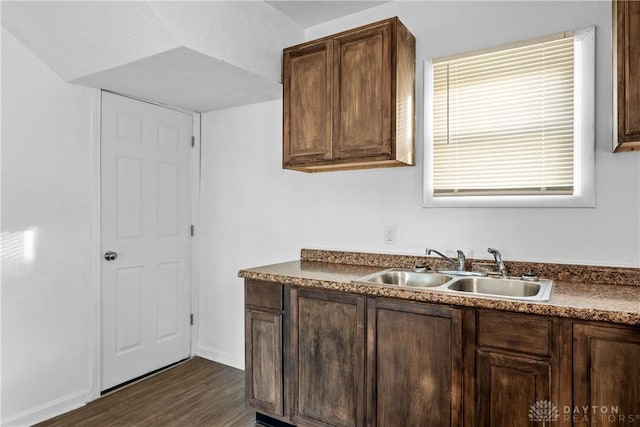 kitchen with dark wood-type flooring, sink, dark brown cabinetry, and a textured ceiling