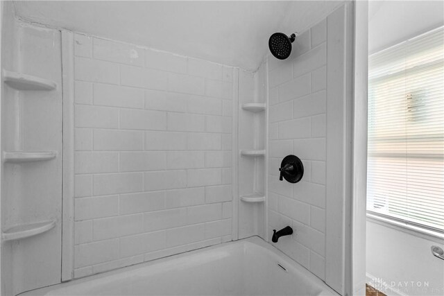 bathroom with tiled shower / bath combo and plenty of natural light