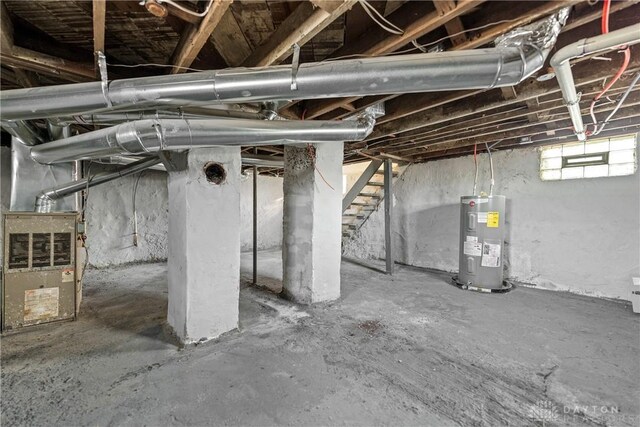 basement with electric water heater and heating unit