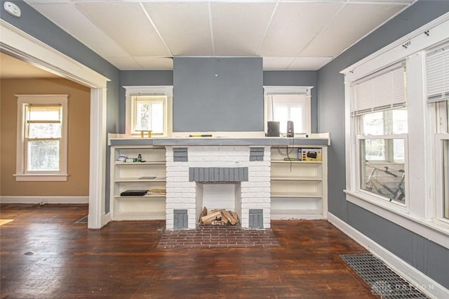 unfurnished living room with dark hardwood / wood-style floors and a fireplace