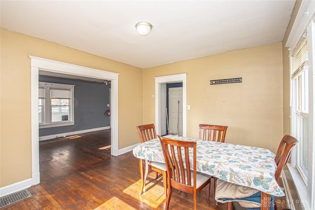 dining space with dark hardwood / wood-style floors