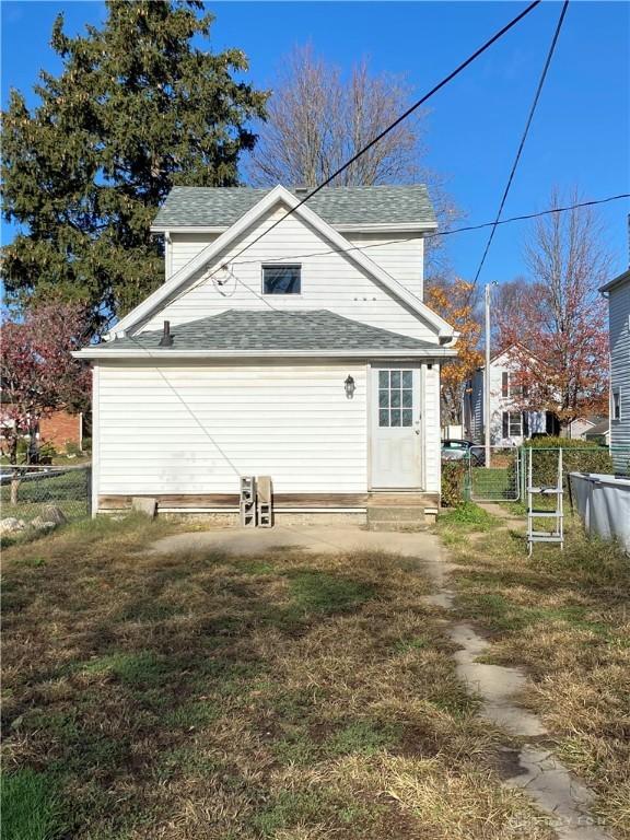 back of house with a lawn