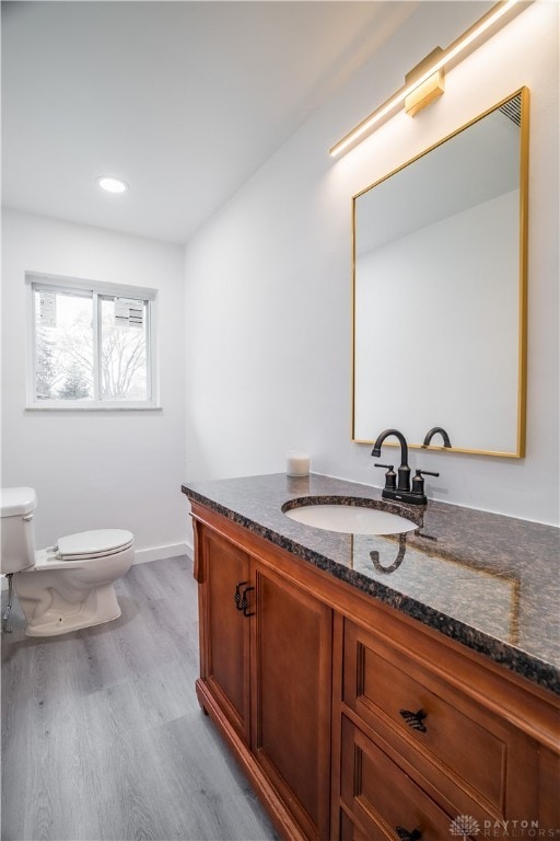 bathroom featuring hardwood / wood-style floors, vanity, and toilet