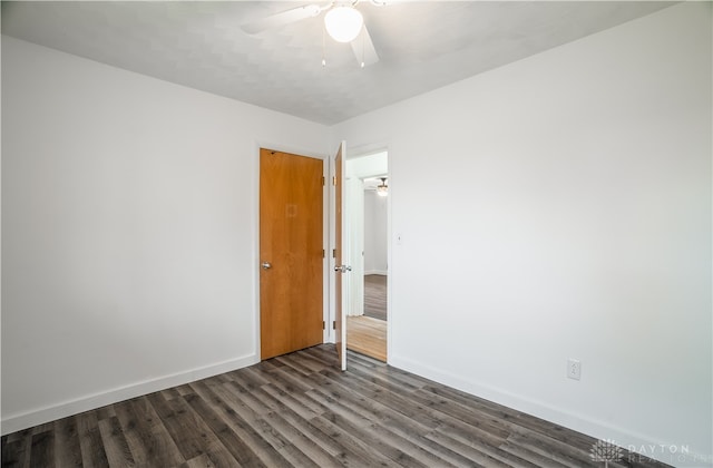 empty room featuring ceiling fan and dark hardwood / wood-style floors