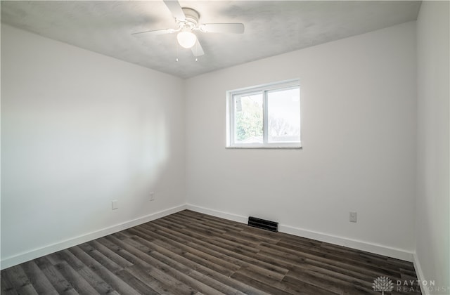 spare room with ceiling fan and dark wood-type flooring