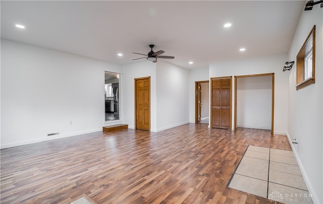 unfurnished bedroom with hardwood / wood-style floors and ceiling fan