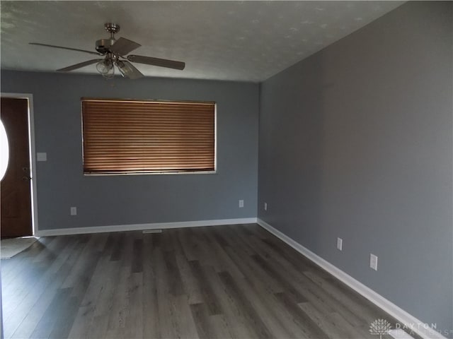 unfurnished room featuring a textured ceiling, dark hardwood / wood-style flooring, and ceiling fan