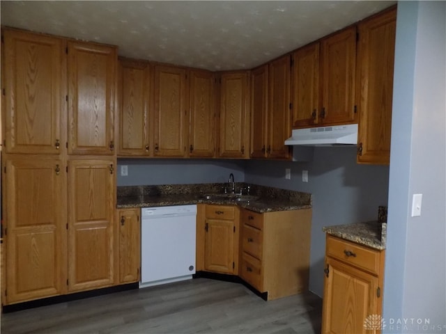 kitchen featuring sink, white dishwasher, and hardwood / wood-style floors