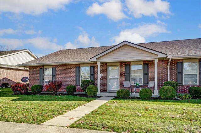 single story home with a porch and a front lawn