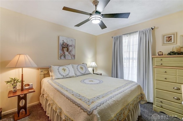 bedroom with ceiling fan and dark carpet