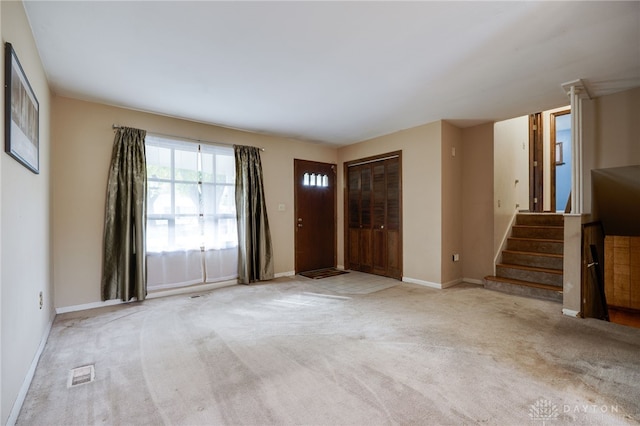 foyer entrance with light colored carpet